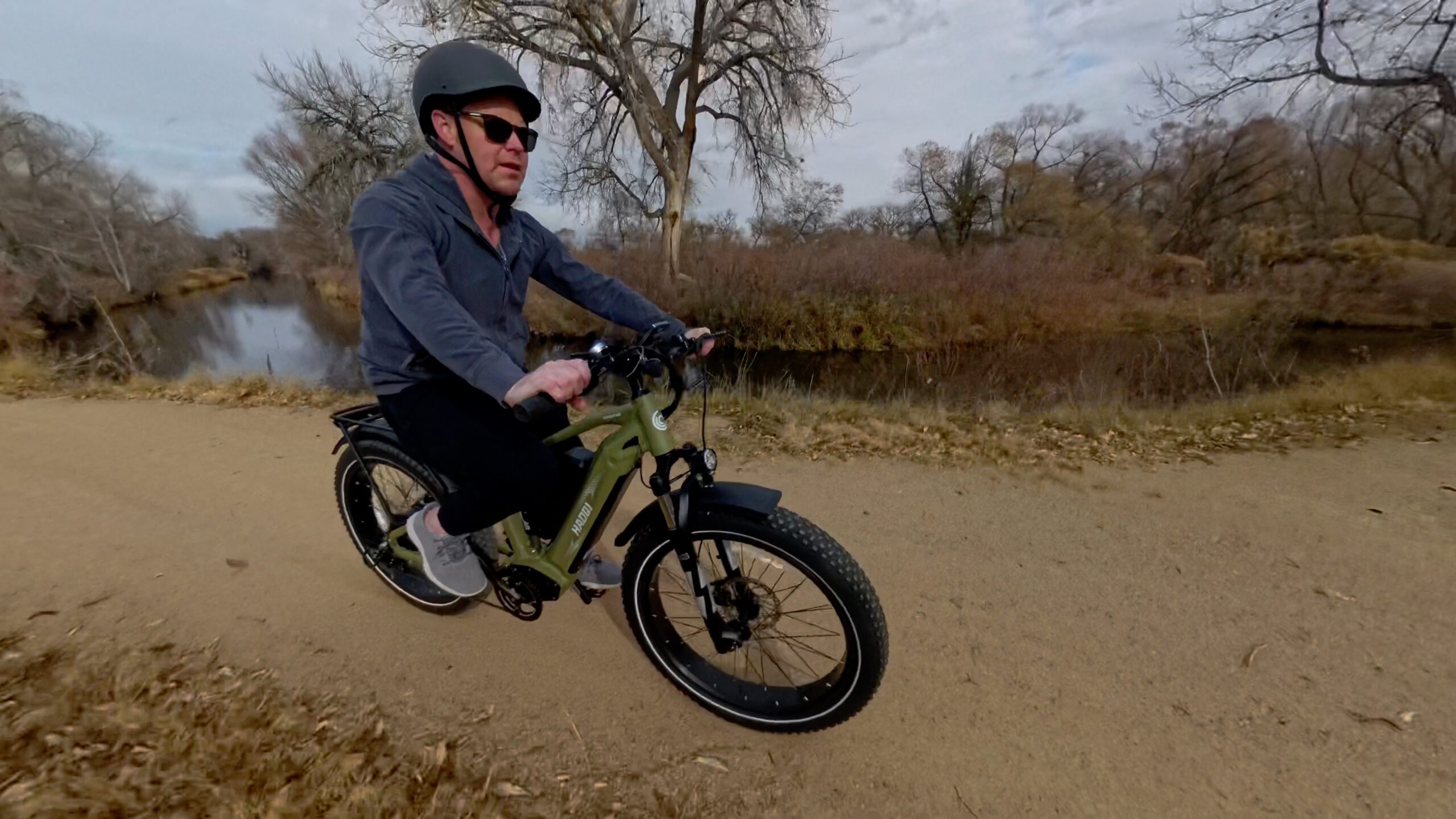 Person riding electric bike on trail.